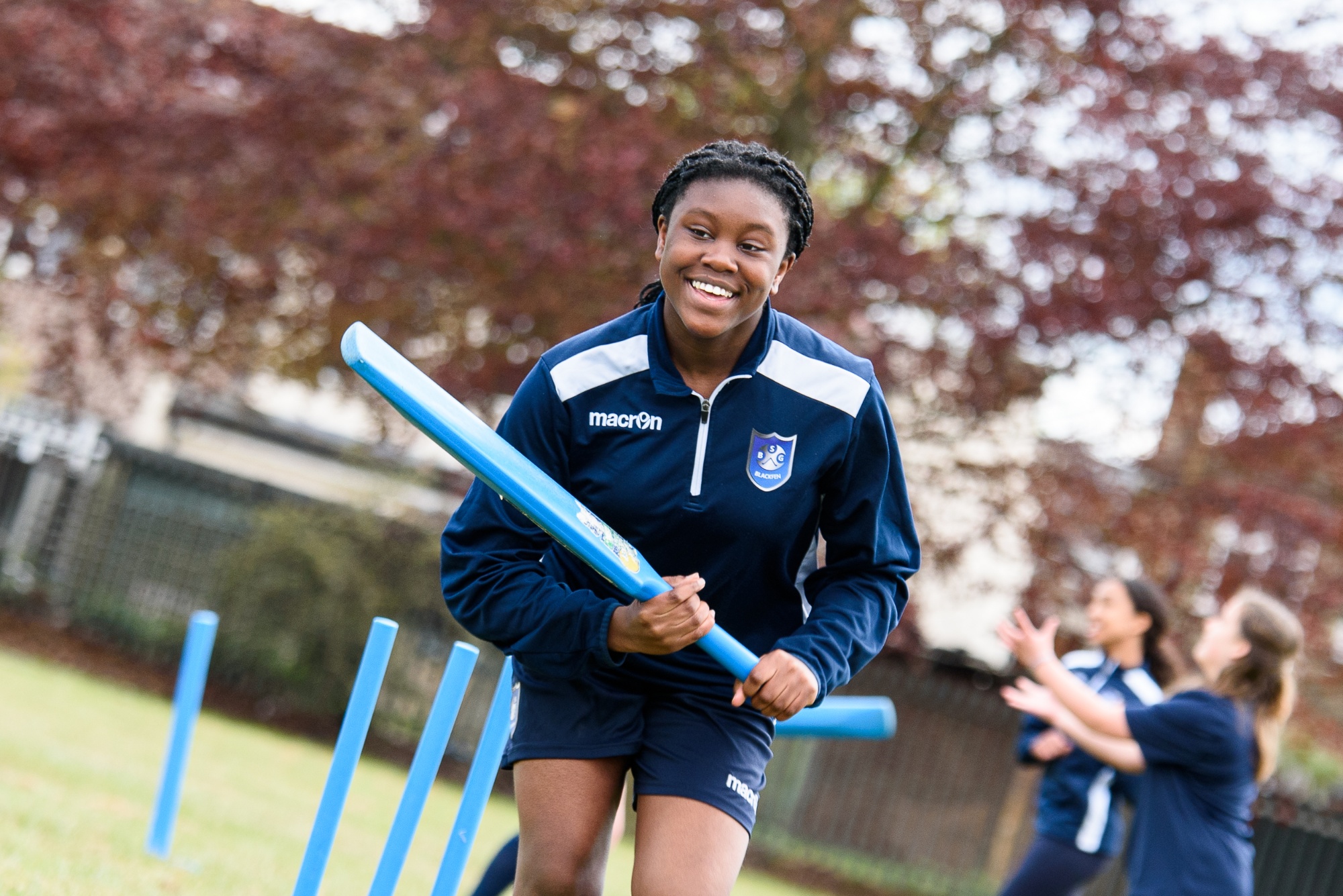 Girl playing cricket - PE lesson