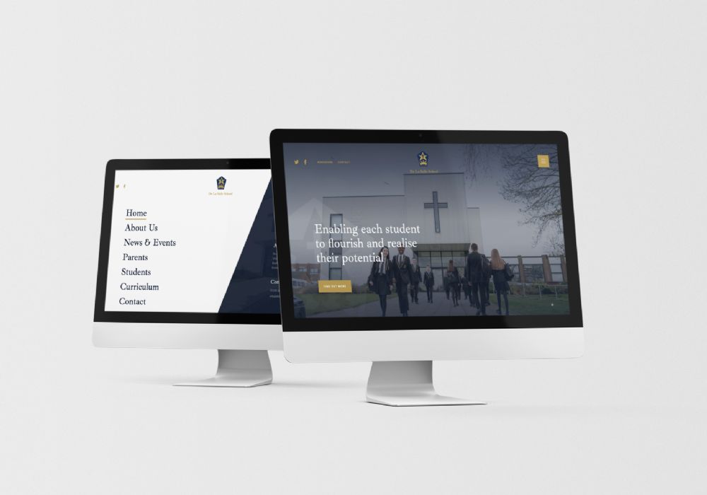 Two angled iMacs showing screenshots of De La Salle's website and menu