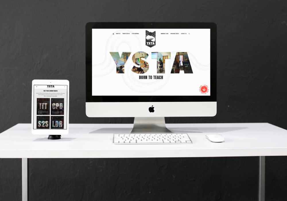 YSTA website on a macbook on a table and an iPad in front of a charcoal background